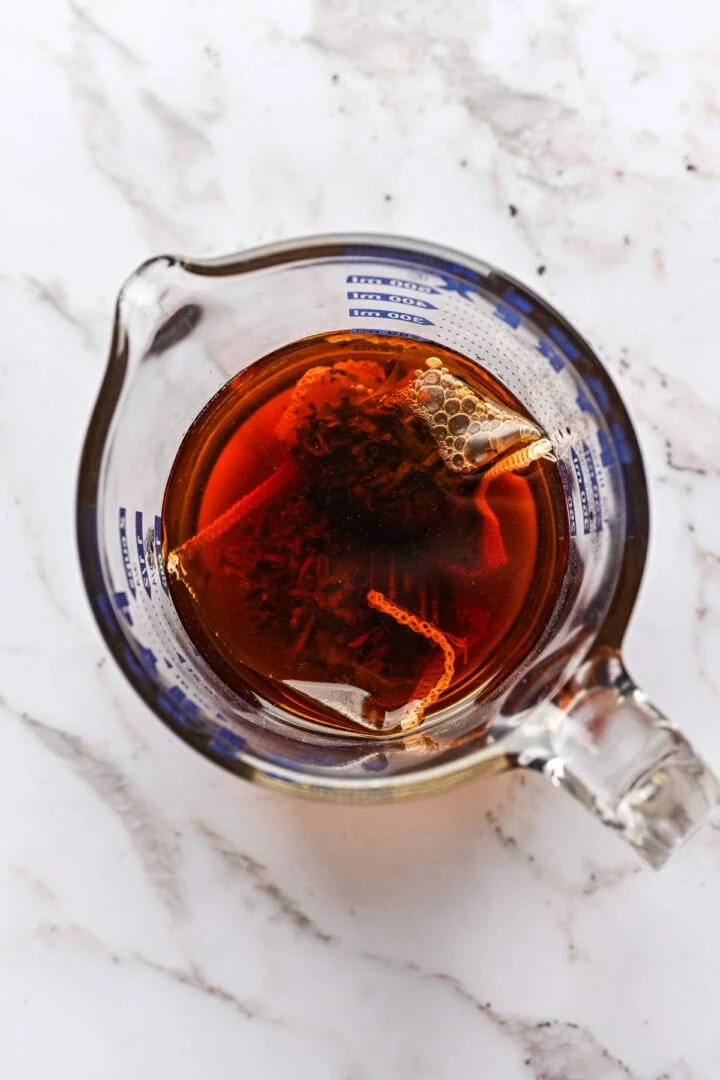 bovenaanzicht van Earl Grey thee die in een maatbeker trekt.
