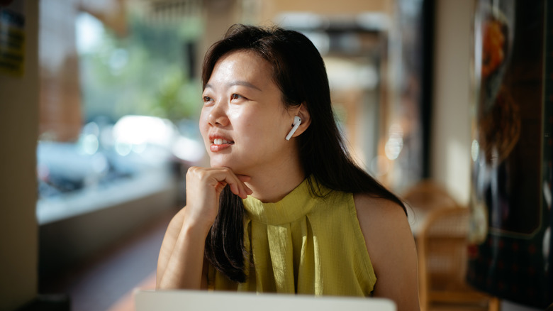 vrouw die oordopjes draagt ​​om ruis te onderdrukken