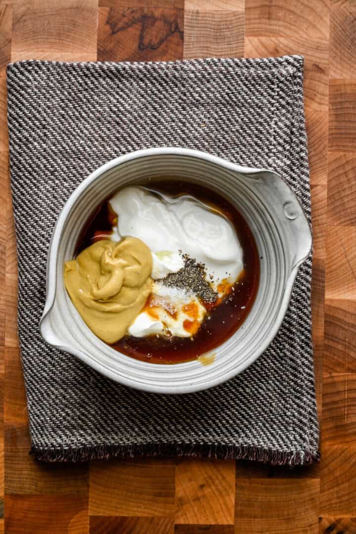 Honingmosterd in een kom voordat het samen wordt geklopt.