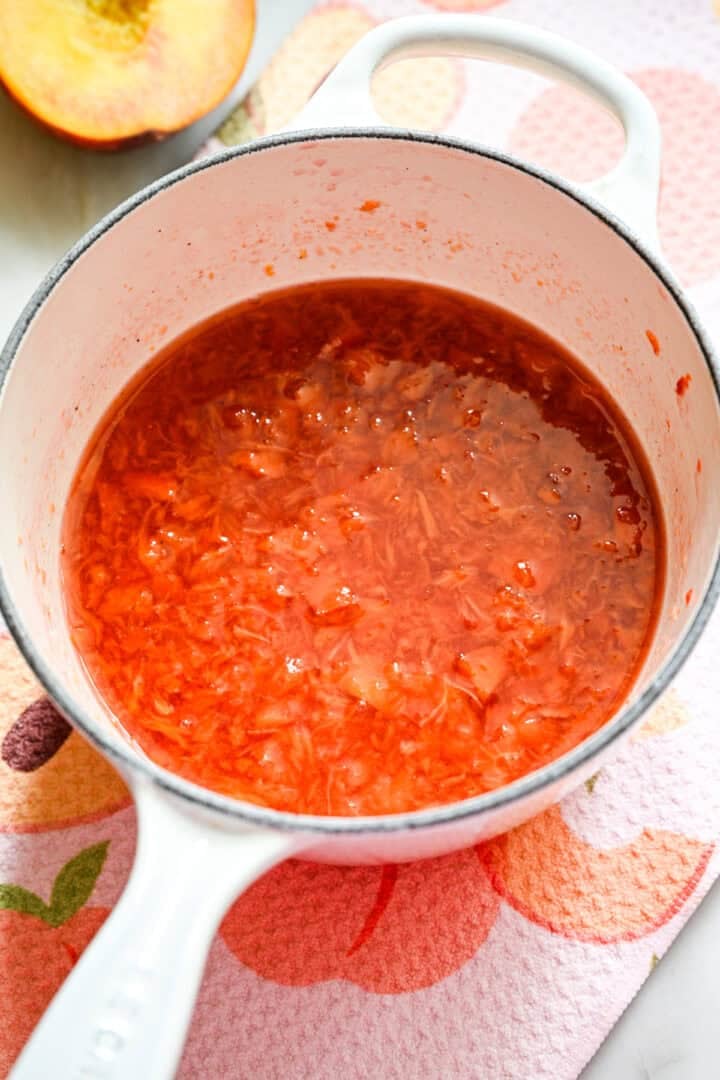 Bovenaanzicht van perziken in een pan na het koken.